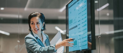 A woman pointing at a computer screen