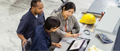 A group of people looking at a tablet together.