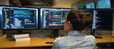 A woman looking at a computer screen.