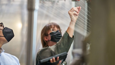 A woman holding a tablet.