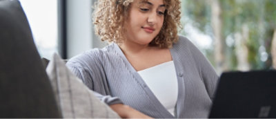 A woman looking down at her phone.