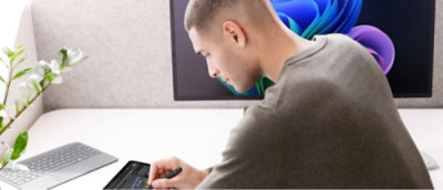 A man looking down at a computer screen.