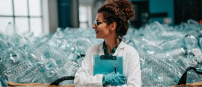 A woman wearing glasses and smiling.