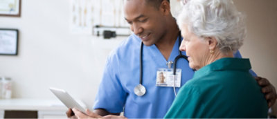 A doctor and patient looking at a tablet.