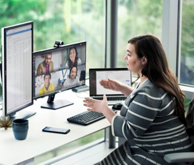 A woman in a suit looking at a computer