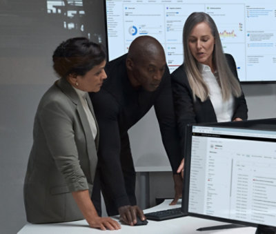 Two women's and one man looking at a computer.