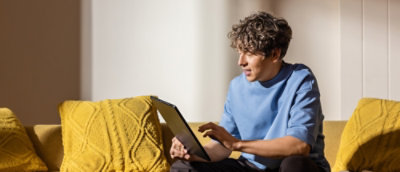  A man using a laptop in office setup.