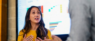 A woman explaining to a group of people