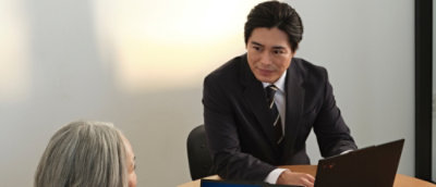 A man in black suit working and discussing .