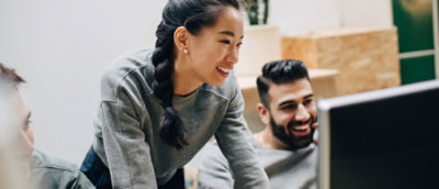 A woman and man discussing while looking at the laptop