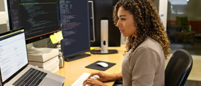 A woman sitting at a desk using a computer.