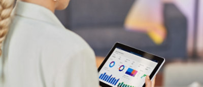A person holding a tablet with a close-up of their shoulder.