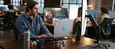 A person sitting at a desk working on a computer.