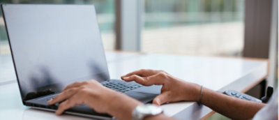A close-up of a hand on a keyboard.