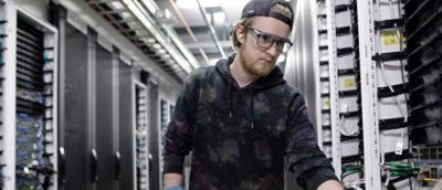 A man wearing a black hat and glasses.