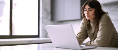 A woman sitting at a desk with a laptop.