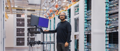 A person wearing headphones and a black shirt standing in a room
