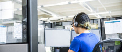 A picture showing back of the woman working on the computer