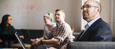A group of people in a meeting looking out