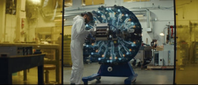 A man in white suit working on a machine