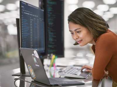 A woman looking at a computer screen.