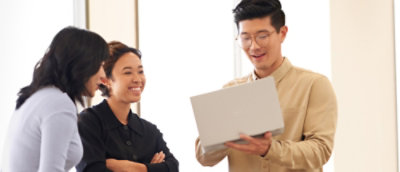 A men showing laptop to other two womens