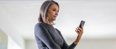 A women look at a cell phone smiling