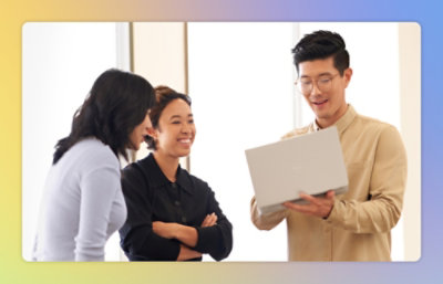 A group of people looking at a laptop.