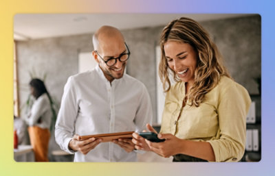 A man and a woman looking at a tablet.
