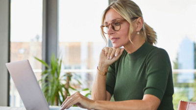 A women working on a laptop.