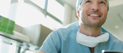 A close-up of a person wearing a white mask.