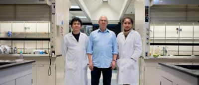 A group of people standing in a hallway.