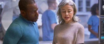 A woman smiling while using a cell phone