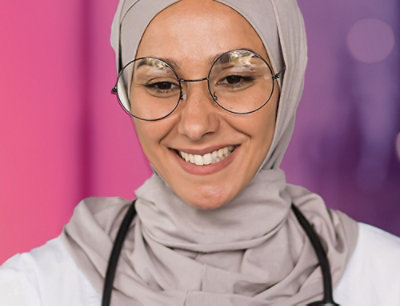 A woman wearing glasses and a headscarf.