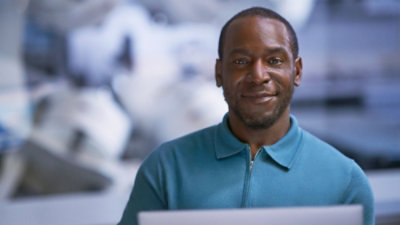 A close-up image of a person in a blue shirt.