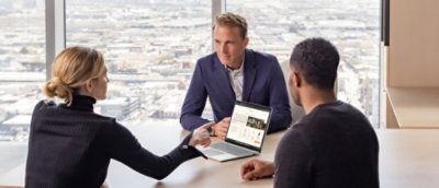 A person pointing at the laptop.