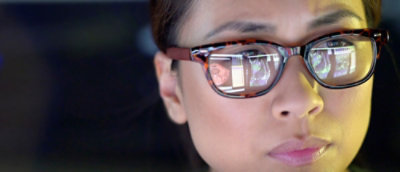 A close-up of a person wearing glasses.