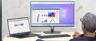 A laptop and a monitor on a desk with a colorful screen.