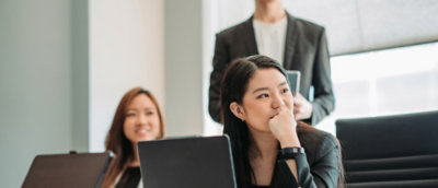 3 people sitting in a meeting and looking out