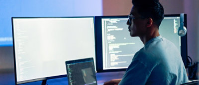 A man looking at the screens