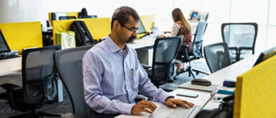 A man working on the laptop in office environment