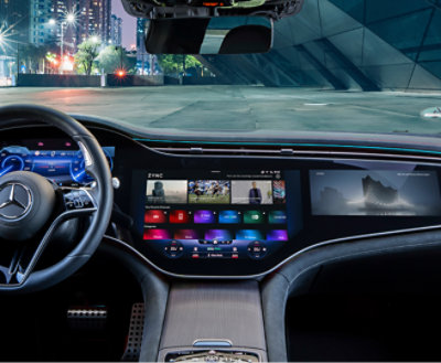 Interior view of a car showcasing a high-tech dashboard with a large touchscreen display and various controls