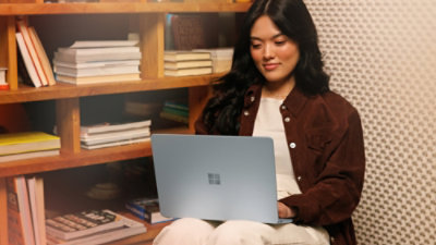 A woman working at a laptop.