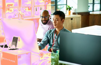 Two persons working on computer