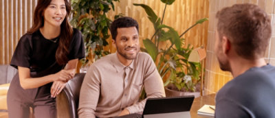 Two men and one women talking with each other.