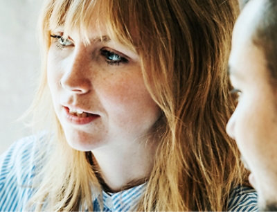 A woman and a man engage in focused conversation.
