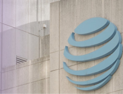A close-up of a logo on a white tile wall.