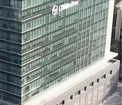 Industrial interior with complex machinery, pipes, and a worker in protective clothing. 