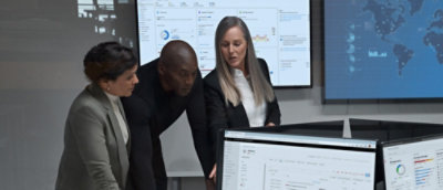 A group of people looking at a computer screen.