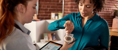 A person holding tablet sharing from jar